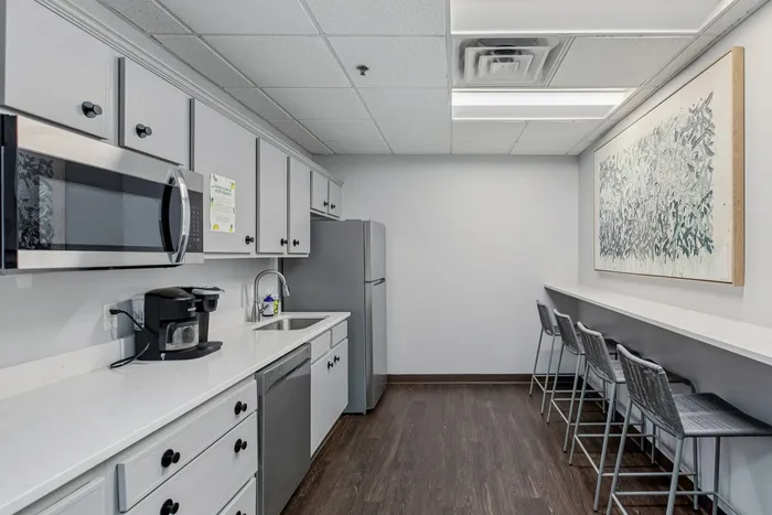 Chic modern kitchen with sleek cabinetry, stainless steel appliances, and a stylish breakfast bar with contemporary seating.