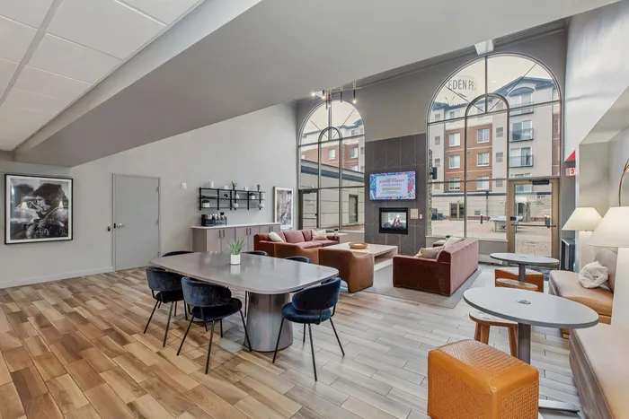Chic modern lounge with a cozy fireplace, large arched windows, and stylish seating area offering a bright, inviting atmosphere.