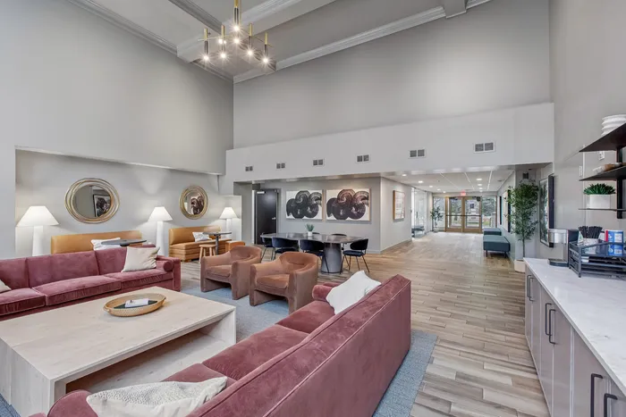 Elegant lounge area with plush seating, modern decor, and high ceilings offering a welcoming atmosphere.