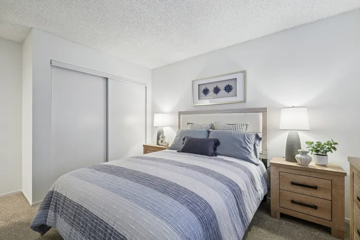 Elegant bedroom with a cozy bed, soft lighting, and modern decor, perfect for relaxation and comfort.