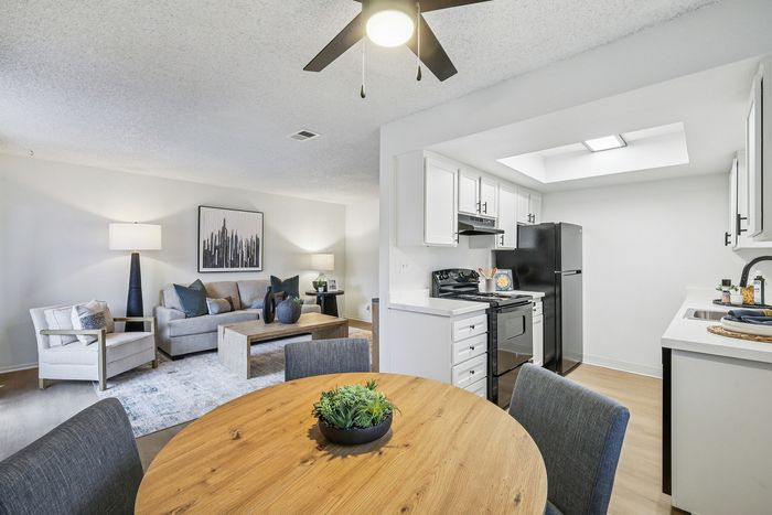 Stylish open-concept apartment featuring a cozy living area with modern decor, and a well-equipped kitchen with sleek appliances.