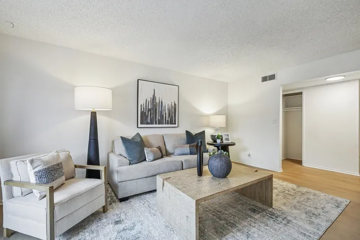 Inviting living room with modern decor, cozy seating, stylish lamps, and elegant artwork.