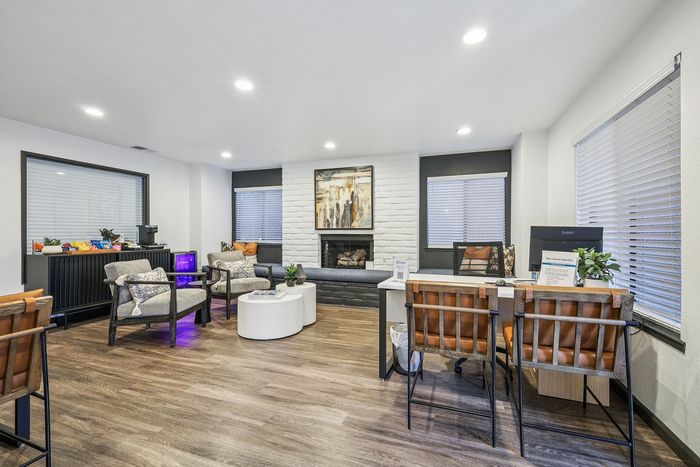 Inviting modern lounge area with stylish seating, vibrant snack bar, and chic fireplace for a cozy ambiance.