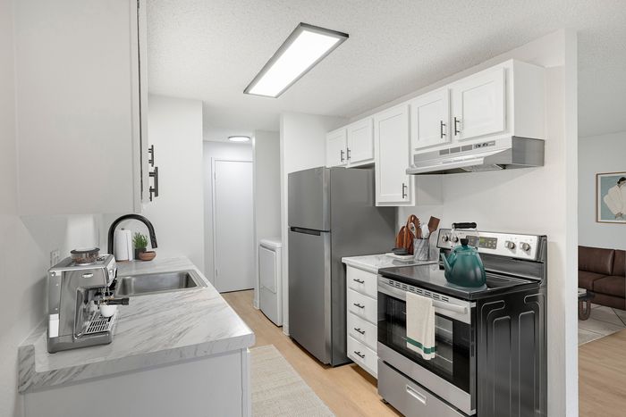 Sleek modern kitchen with stainless steel appliances, marble countertops, and an inviting open layout.