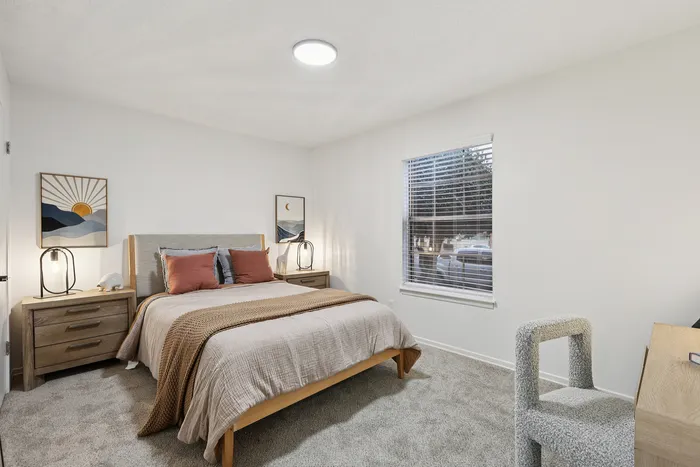 Cozy bedroom with modern decor, featuring a plush bed, stylish nightstands, and a serene window view.