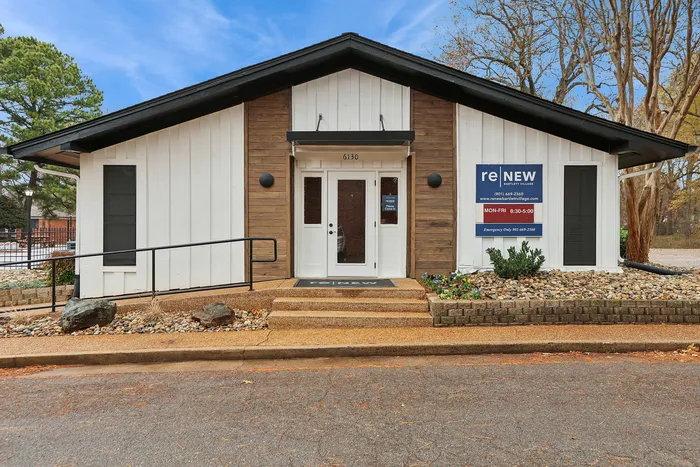 Inviting office exterior at Renew Bartlett Village with modern architecture, neatly landscaped entrance, and vibrant signage.