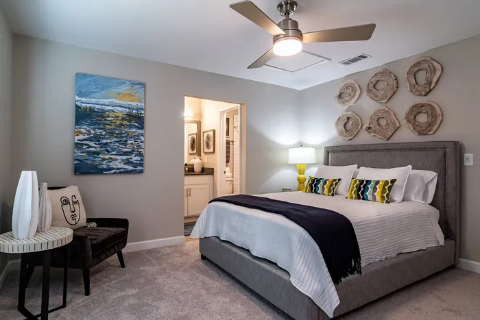 Elegant bedroom with modern decor, featuring a plush bed, stylish wall art, and soft lighting, creating a serene and cozy atmosphere.