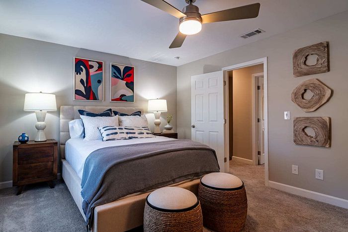 Chic bedroom with stylish artwork, cozy lighting, and modern decor, perfect for relaxation and comfort.