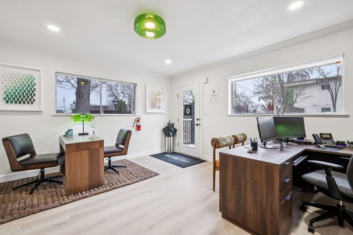 Modern, elegant office space with sleek wooden desks, stylish chairs, and bright natural lighting enhancing productivity.