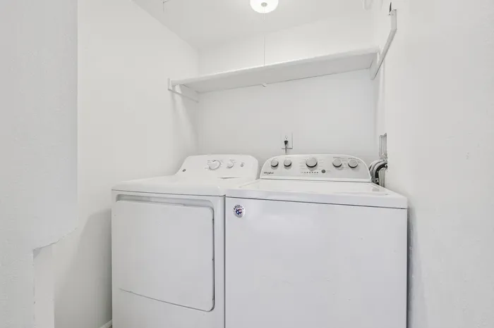 Bright and airy laundry room featuring modern washer and dryer, perfectly integrated for convenience and functionality.