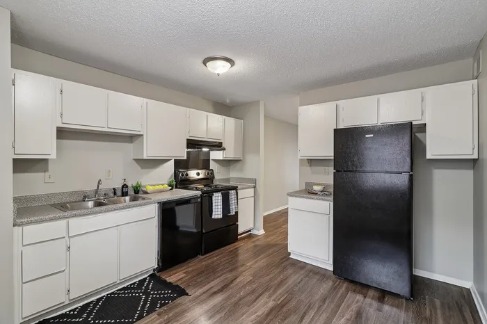 Modern kitchen featuring sleek white cabinets, stylish countertops, and stainless steel appliances.