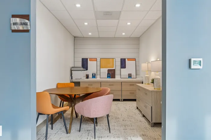 Chic Wi-Fi lounge with modern furnishings, vibrant art pieces, and cozy seating perfect for relaxation or work.