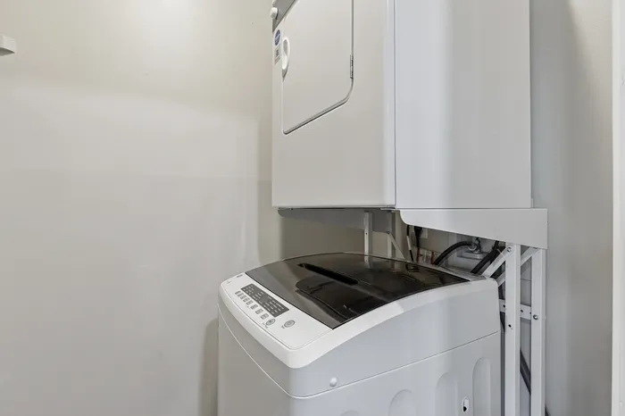 Modern laundry nook featuring a sleek stackable washer and dryer, perfect for convenient apartment living.
