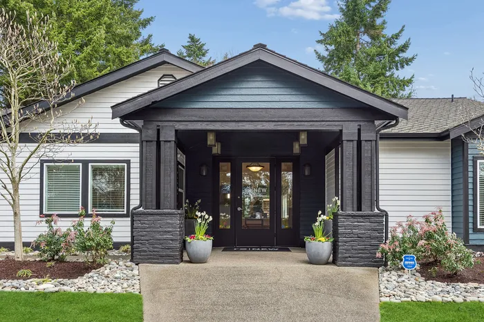Charming residential entrance with elegant landscaping, featuring a modern design and inviting ambiance.