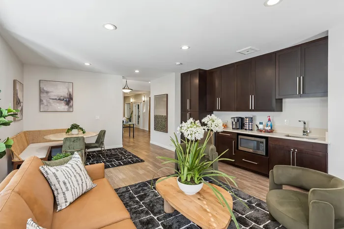 Contemporary open-concept living space with sleek kitchen, cozy seating area, and stylish decor.