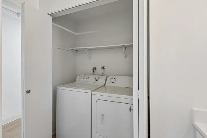Contemporary laundry area featuring an efficient washer and dryer set, perfect for modern living convenience.