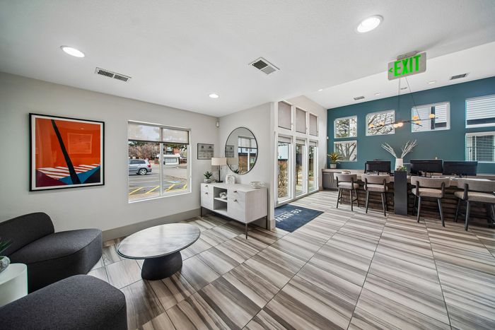 Bright and modern lobby area with stylish decor, sleek furniture, and ample natural light pouring in through large windows.
