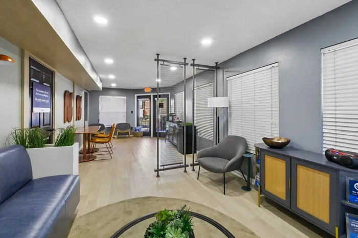 Modern, stylish apartment lounge area featuring sleek furniture, vibrant decor, and abundant natural light, perfect for relaxation and gatherings.