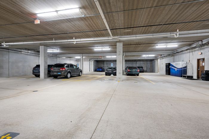 Spacious, well-lit underground parking garage with multiple parking spots available, offering convenience and security.