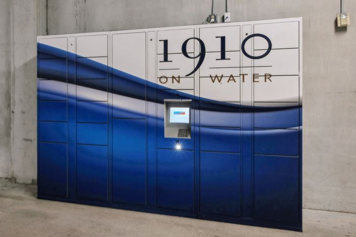 Elegant parcel locker with a modern blue wave design at 1910 on Water, showcasing sleek and secure package management.