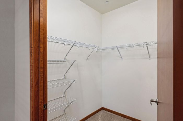 Spacious walk-in closet featuring sleek wire shelving for optimal organization.