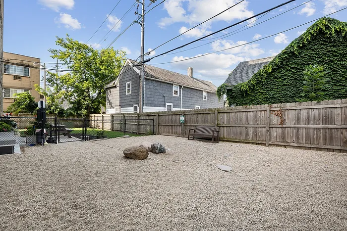 Charming outdoor area with seating and lush greenery, perfect for relaxation and entertainment.