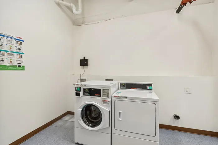 Modern laundry room with high-efficiency washer and dryer, clean and well-lit space perfect for all your laundry needs.