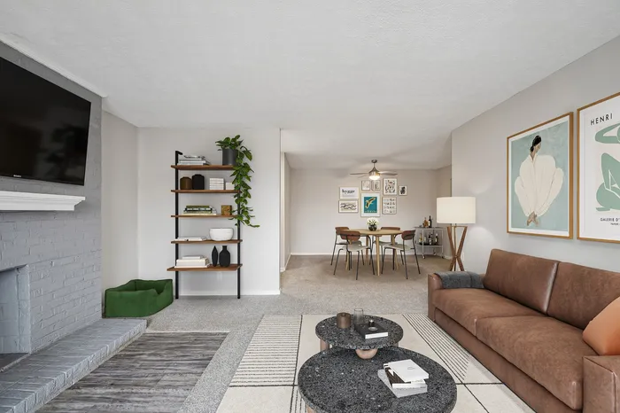 Inviting living area with plush brown couch, elegant wall art, and cozy dining space perfect for entertaining.