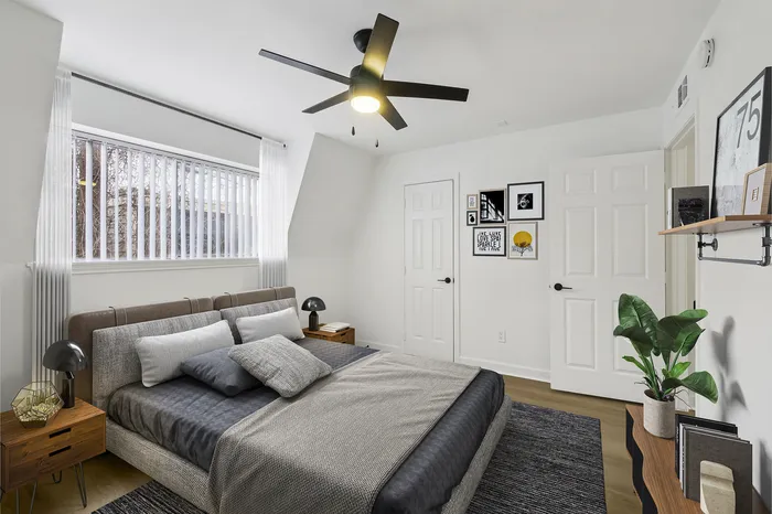 Modern bedroom with stylish decor, featuring a cozy bed, elegant lighting, and chic wall art.