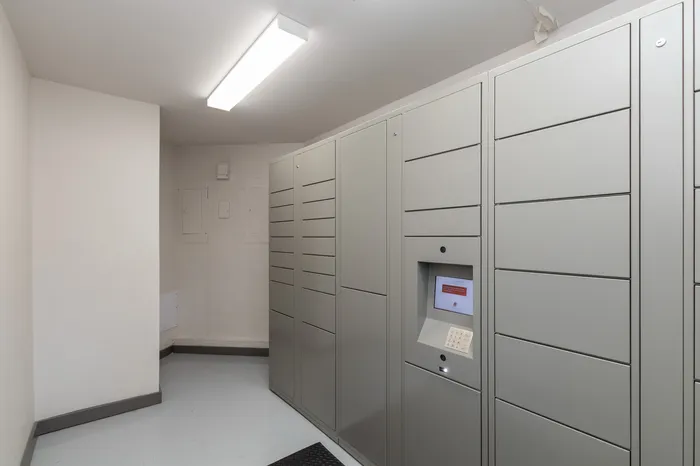 Modern mailroom with secure package lockers and digital access panel, providing convenience and safety for residents.