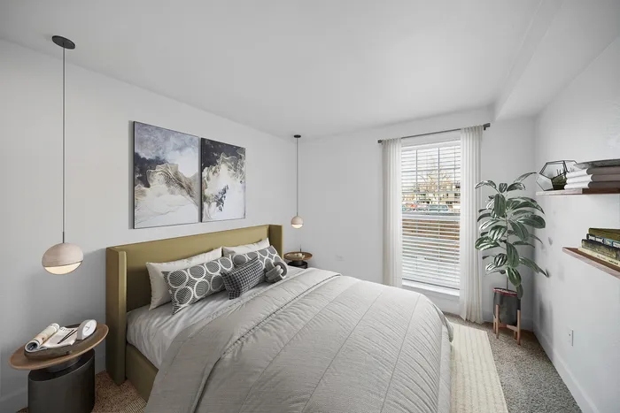 Modern bedroom with stylish decor, featuring a cozy bed with patterned pillows, elegant hanging lights, and large window offering natural light.