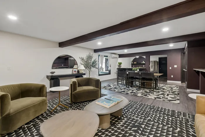 Elegant and spacious open-concept living area with contemporary decor, featuring plush seating and a stylish dining space.