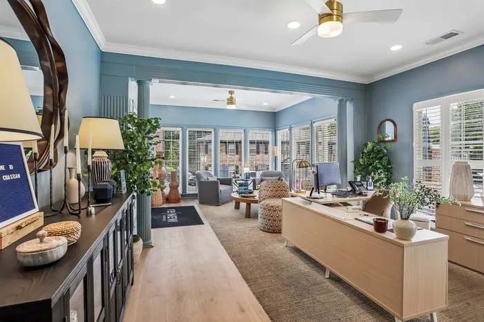 Inviting apartment lobby featuring elegant decor, natural lighting from multiple windows, and a modern reception desk.