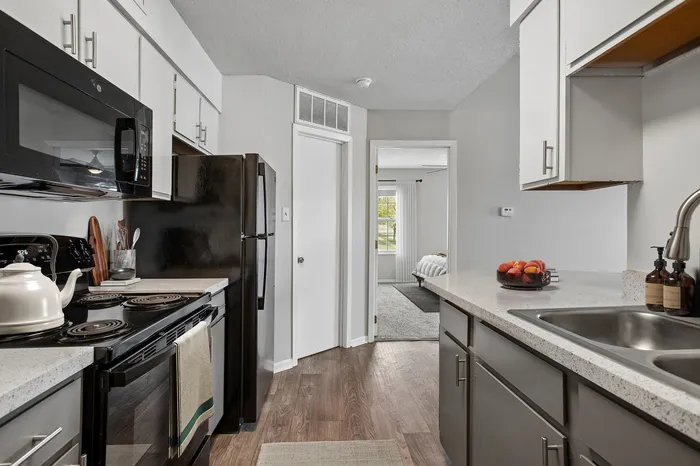 Modern kitchen with sleek appliances, cozy adjacent bedroom, and inviting design elements perfect for contemporary living.