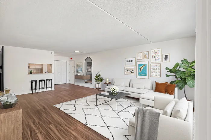 Modern living room with elegant decor, wooden floors, and a cozy sectional sofa offering an inviting atmosphere.