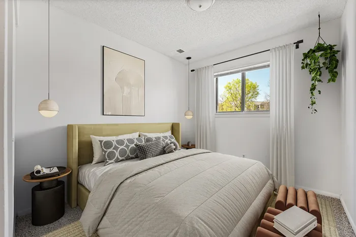 Charming bedroom with modern design, featuring large window, elegant hanging lights, and lush greenery for a serene ambiance.