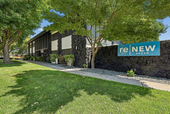 Inviting exterior of ReNew Arden featuring lush green surroundings and modern architectural design.