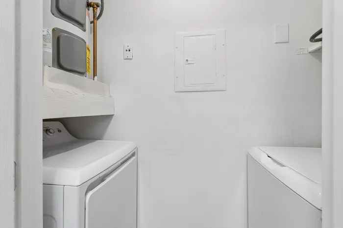 Modern laundry room with sleek washer and dryer setup, featuring efficient space-saving design.