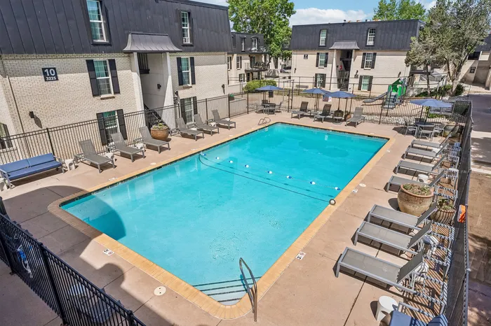 Inviting outdoor pool area with lounge chairs and vibrant surroundings, perfect for relaxation and leisure.