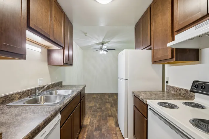 Inviting kitchen with elegant wooden cabinetry, modern appliances, and stylish countertops, perfect for culinary enthusiasts.