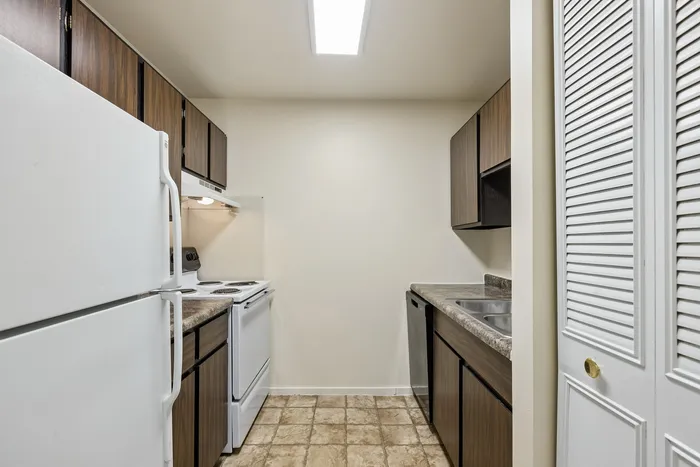 Charming compact kitchen with modern appliances and sleek cabinetry, offering functionality and style.