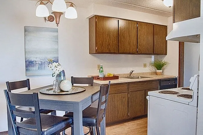 Charming kitchen with stylish wooden cabinets, cozy dining area, and elegant lighting, perfect for intimate gatherings.