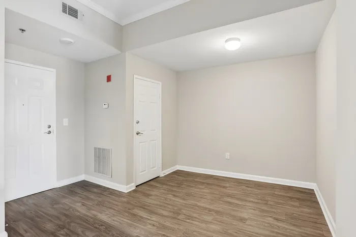 Elegant, spacious entryway with bright lighting and sleek wood flooring, ideal for a modern aesthetic.