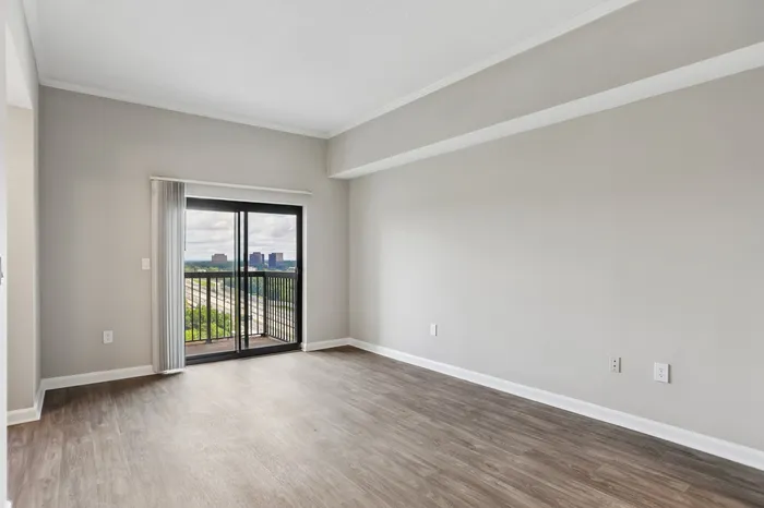 Chic living space with floor-to-ceiling windows and an expansive city view, perfect for modern living.