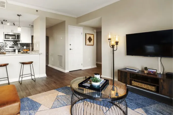 Inviting modern living space with a stylish open kitchen, elegant lighting, and contemporary decor.