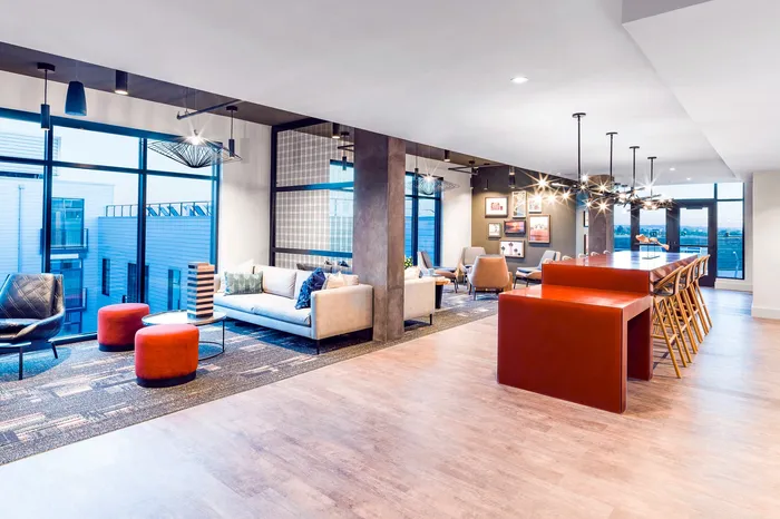 Modern open-concept living space featuring sleek furniture, stylish lighting, and large windows offering abundant natural light.
