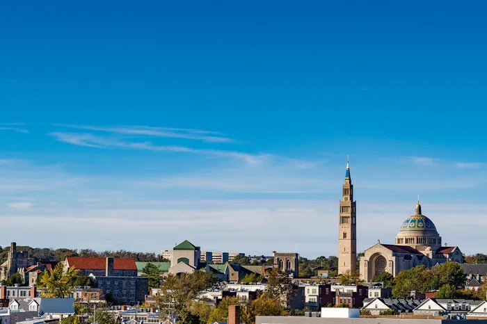 Vibrant cityscape featuring iconic architecture against a clear blue sky, perfect for a serene urban lifestyle.