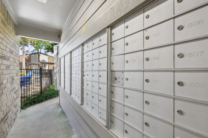 Secure and convenient apartment mailbox area with well-organized lockable mailboxes, enhancing community living experience.