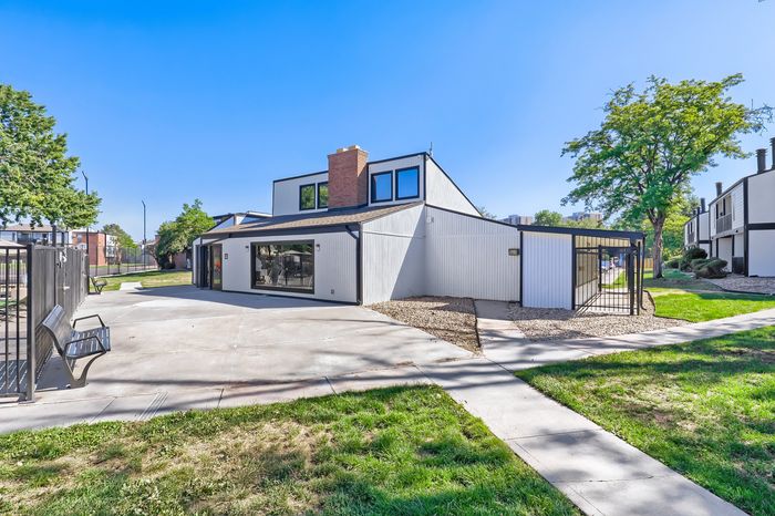 Charming modern townhouse with stylish exterior and lush surrounding greenery, perfect for serene suburban living.