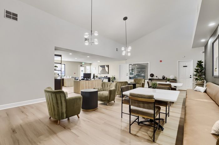 Elegant open-concept living area with modern furnishings, chic lighting, and a welcoming atmosphere.